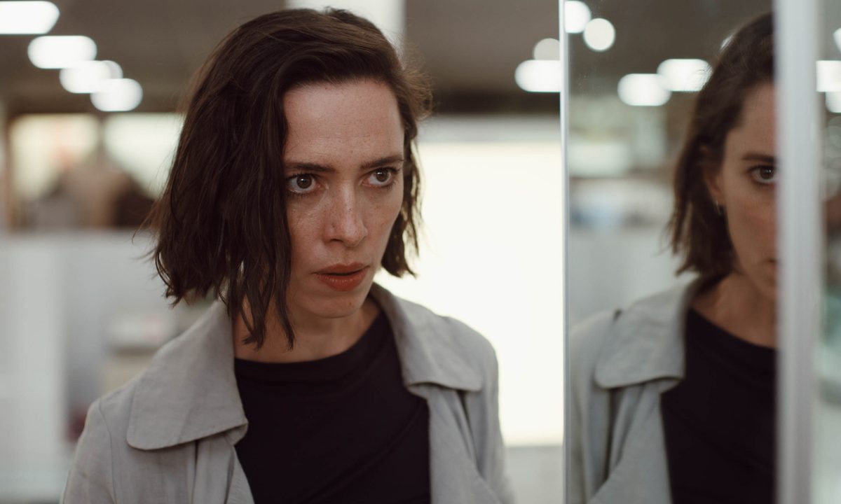 Rebecca Hall stands next to a mirrored wall in Resurrection.