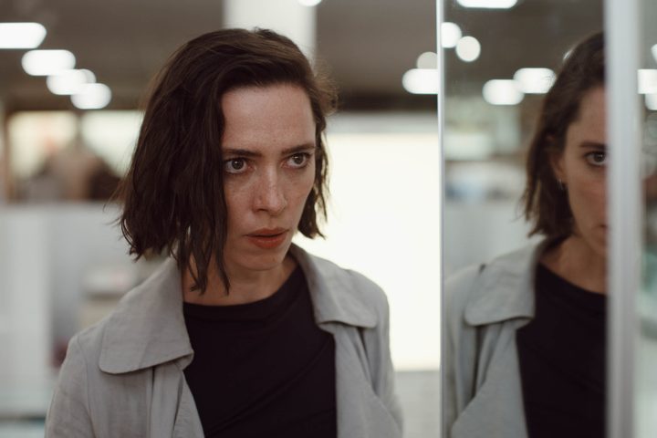 Rebecca Hall stands next to a mirrored wall in Resurrection.