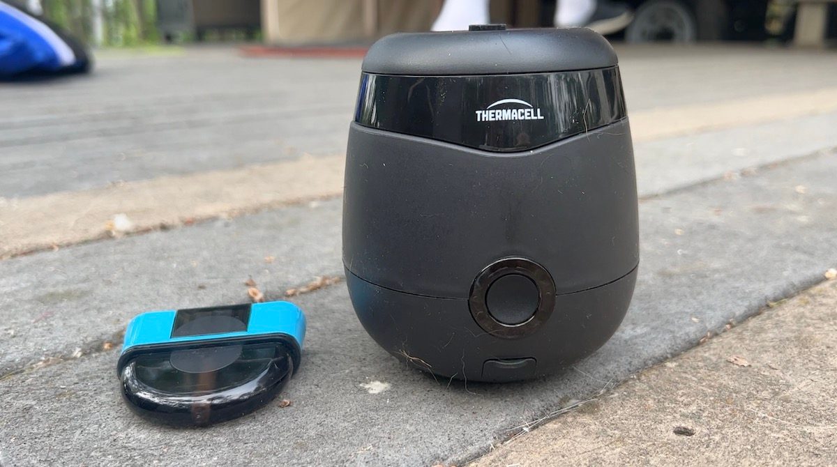 Thermacell Radius and liquid repellant cartridge siting on a wood deck.