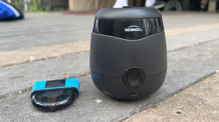 Thermacell Radius and liquid repellant cartridge siting on a wood deck.