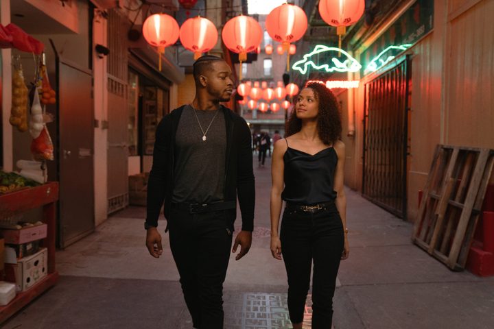 Stephan James and Gugu Mbatha-Raw walk down an alley together in Surface.