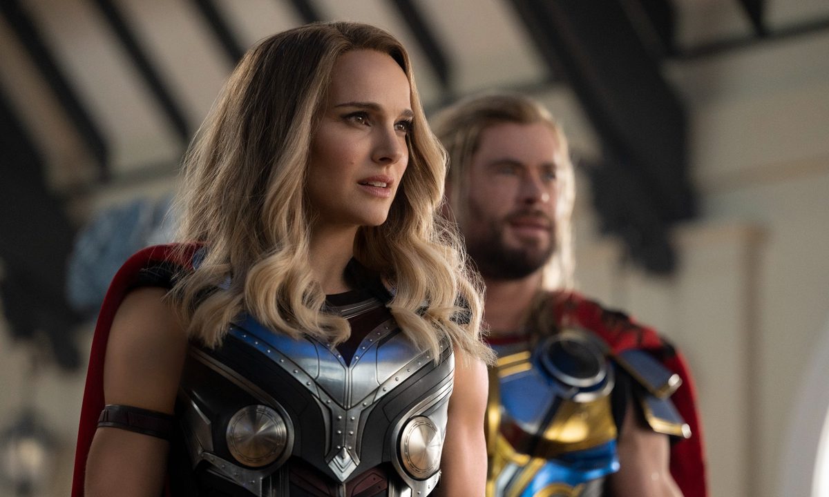 Natalie Portman and Chris Hemsworth pose as Thors in Thor: Love and Thunder..