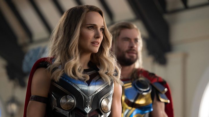Natalie Portman and Chris Hemsworth pose as Thors in Thor: Love and Thunder..