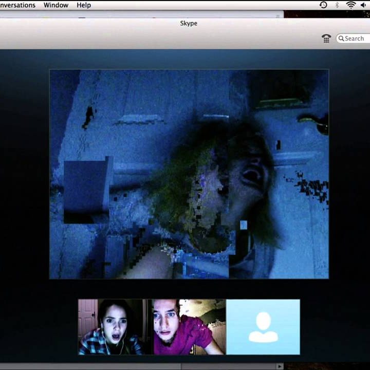 A teenager girl screams in terror in a Skype window while her friends helplessly watch.
