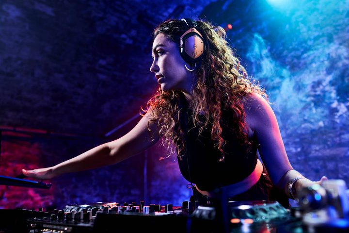 Woman DJ wearing V-Moda Crossfade 3 Wireless headphones