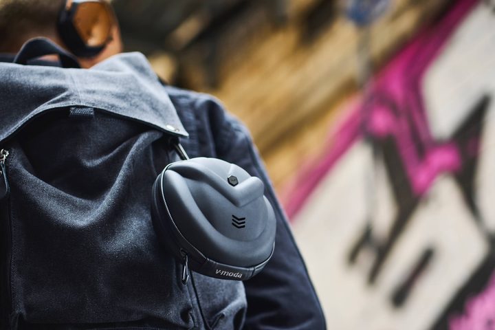 Person carrying V-Moda Crossfade 3 Wireless headphones in case slung over shoulder.
