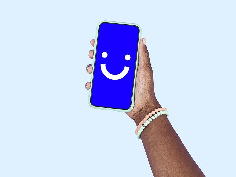 Visible wireless logo on phone that's being held up.