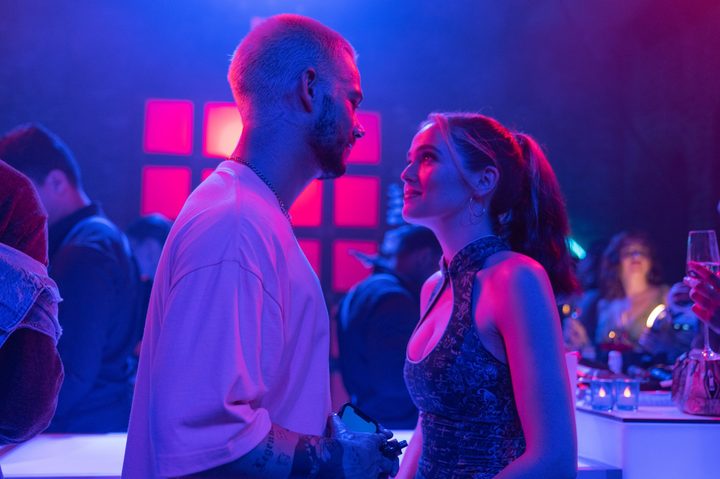 Zoey Deutch and Dylan O'Brien look at each other in Not Okay.