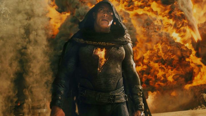 Black Adam walks away from an explosion in Black Adam.