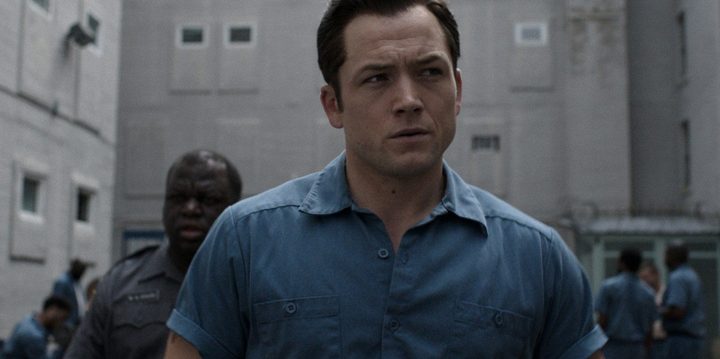Taron Egerton walks through a prison yard in a scene from Black Bird.