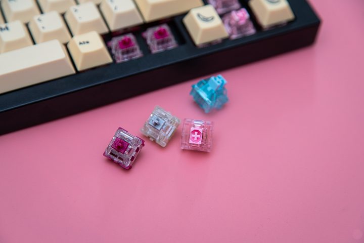 Several switches sitting in front of a keyboard.