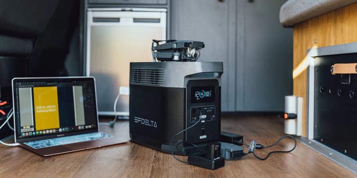 Ecoflow generator on the floor next to a laptop.