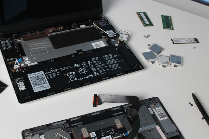 Upgrading the Framework Laptop with the components on a table.
