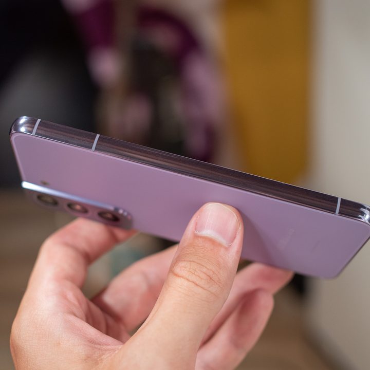 Purple Samsung Galaxy S22 held in hand.