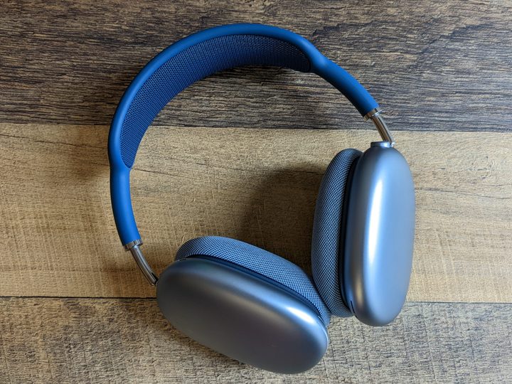 A pair of blue AirPods Max sitting on a table.