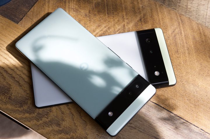 The Google Pixel 6a laying on top of the Google Pixel 6.