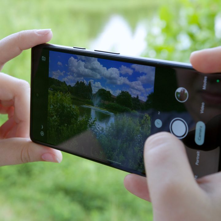 The Google Pixel 6a. Someone is holding the phone with the camera app open.