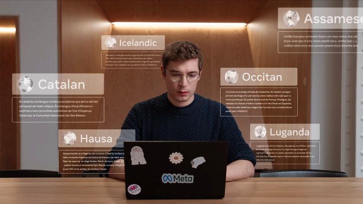 Image with languages displaying in front of a man on his laptop for Meta's 200 languages within a single AI model video.