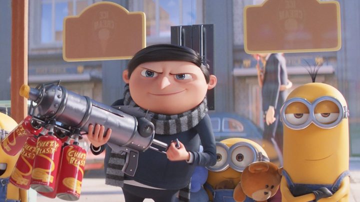 Gru holds a cheese-spraying rifle, surrounded by his Minions.