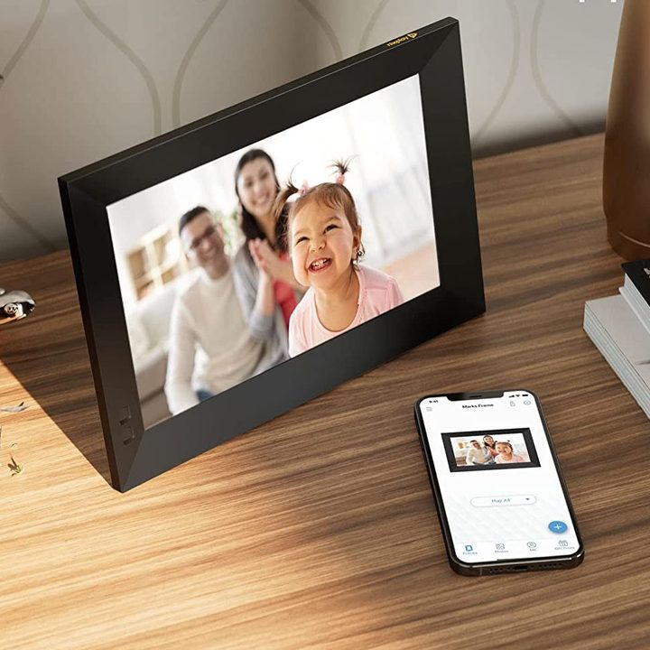 Digital photo frame on a console table.