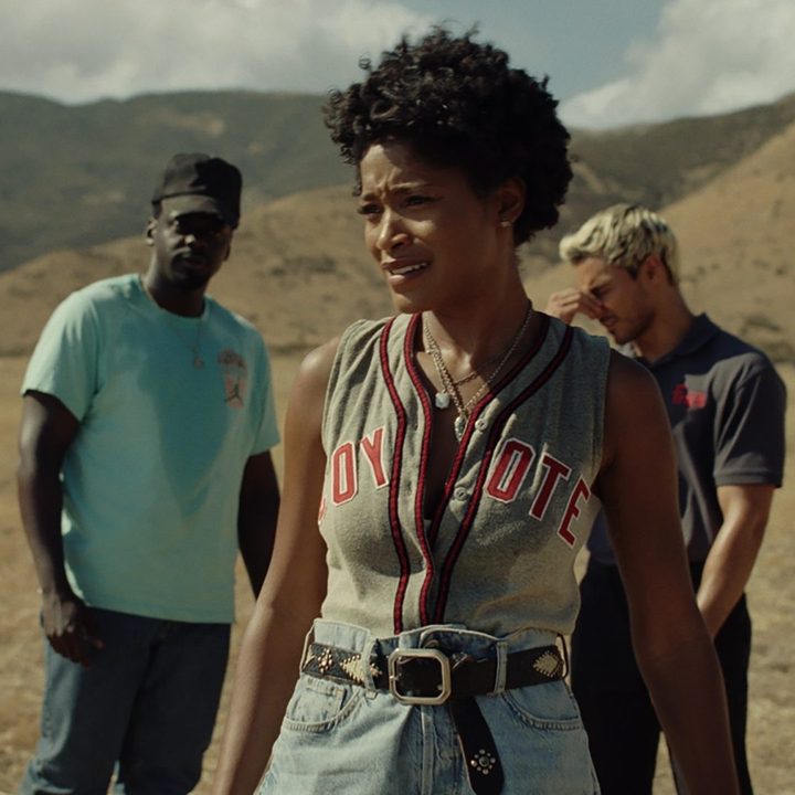 Keke Palmer stand sin front of Daniel Kaluuya and Brandon Perea on a long dirt road in a scene from Nope.