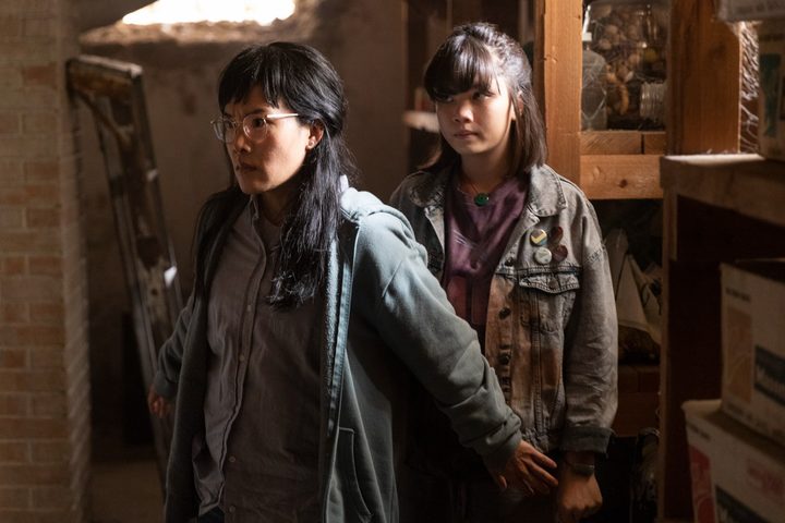 Ali Wong stands in front of Riley Lai Nelet in a scene from Paper Girls.