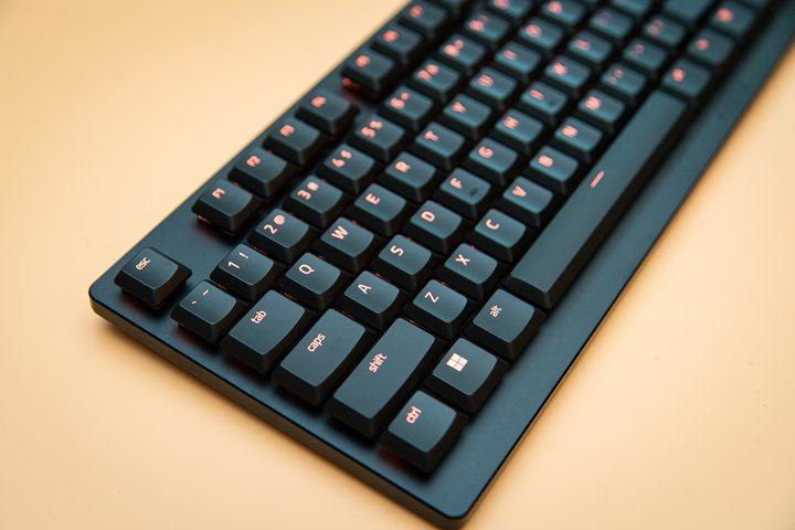 Razer DeathStalker V2 sitting on an orange background.