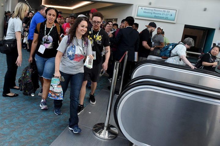 Patrons ride an escalator at San Diego Comic-Con.