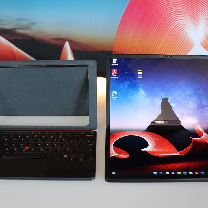 The 2022 ThinkPad X1 Fold in clamshell model next to its stand and keyboard.