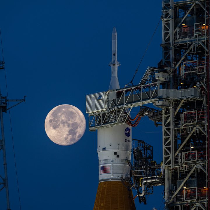 A full Moon in view on June 14, 2022 behind the Space Launch System and Orion spacecraft atop the mobile launcher at Launch Complex 39B at NASA’s Kennedy Space Center in Florida.