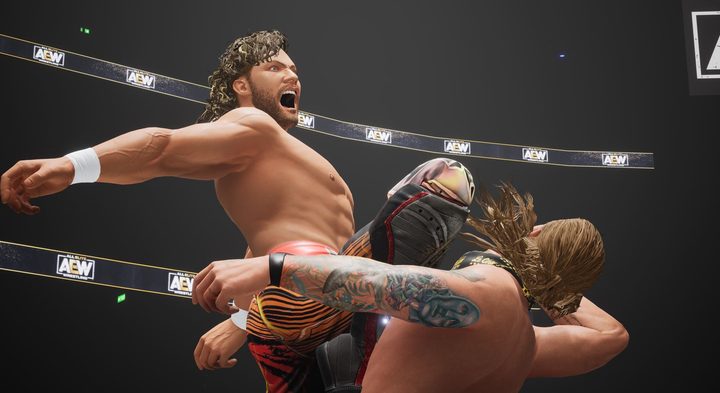 A Wrestler knees his opponent in the face.