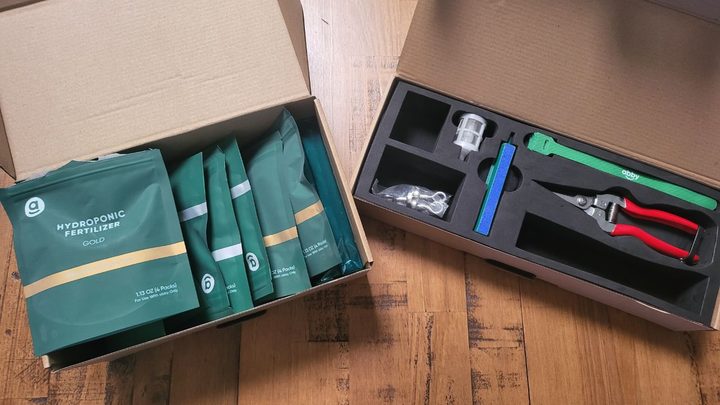 Two boxes of tools and fertilizer that come with Abby Grow Box.