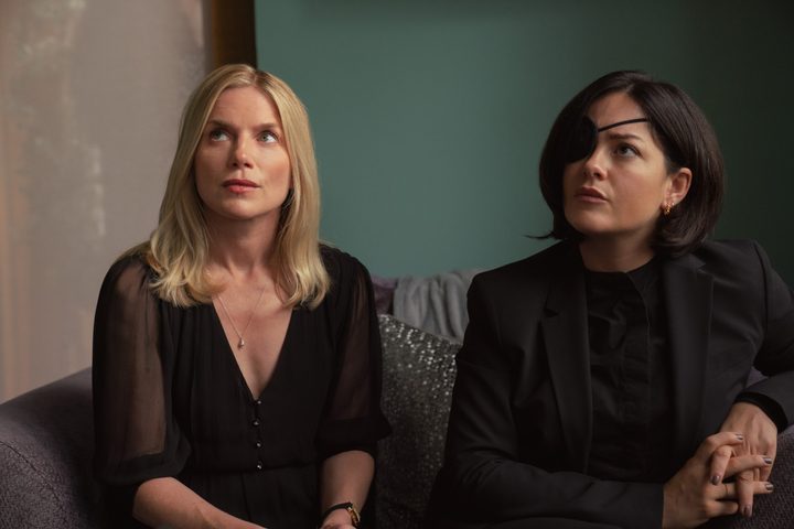 Two sisters sit next to each other in Bad Sisters.