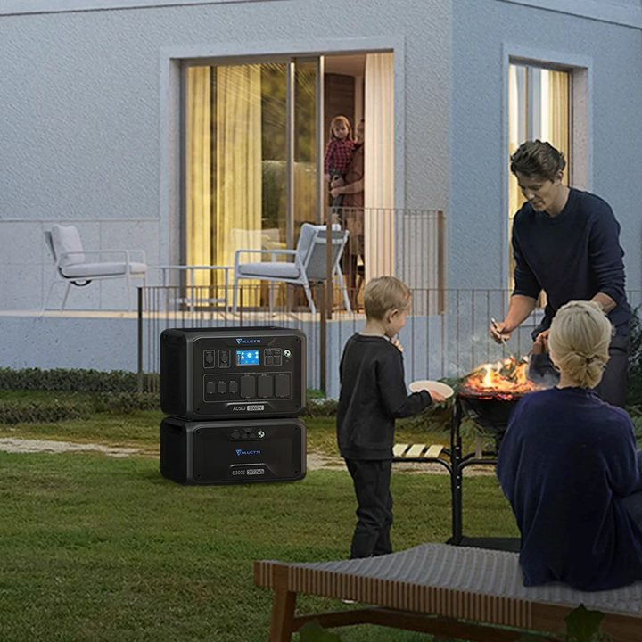 Bluetti AC500 and B300S combo used outside next to a family having a barbecue.