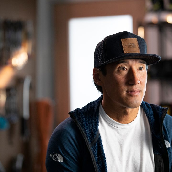 Jimmy Chin sitting and posing in a scene from Edge of the Unknown.