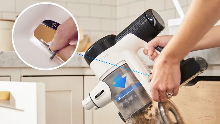 Using the Tineco quick release to empty the dustbin.
