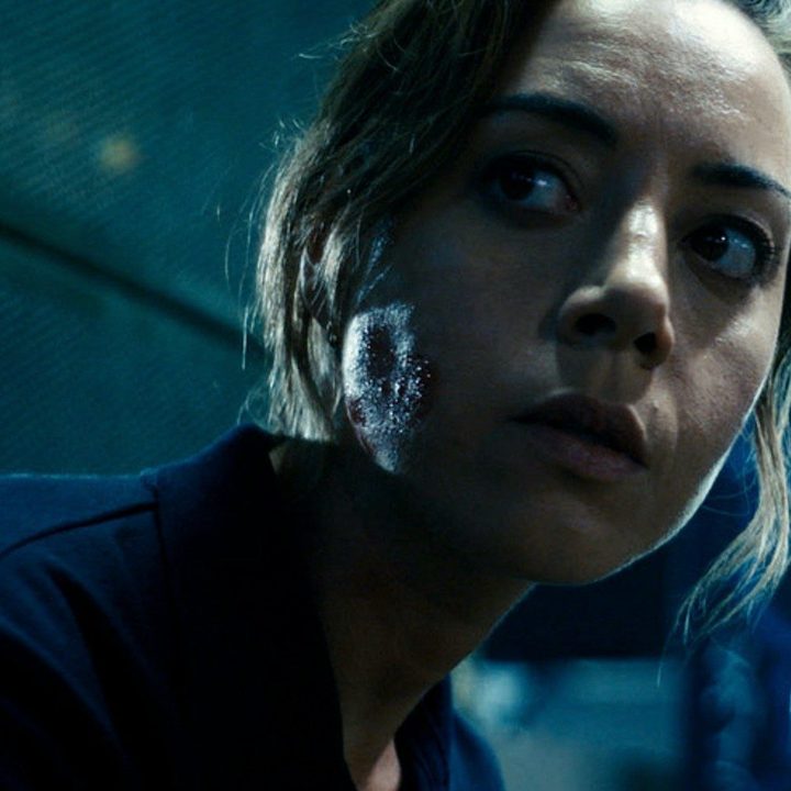 Aubrey Plaza looks behind her in Emily the Criminal.