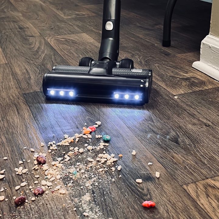 The Levoit VortexIQ 40 suctioning cereal on the floor.