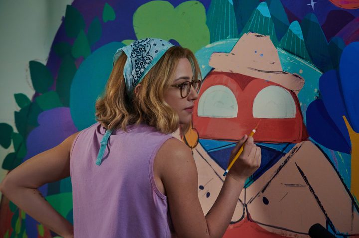 Lili Reinhart holds a paint brush in Look Both Ways.