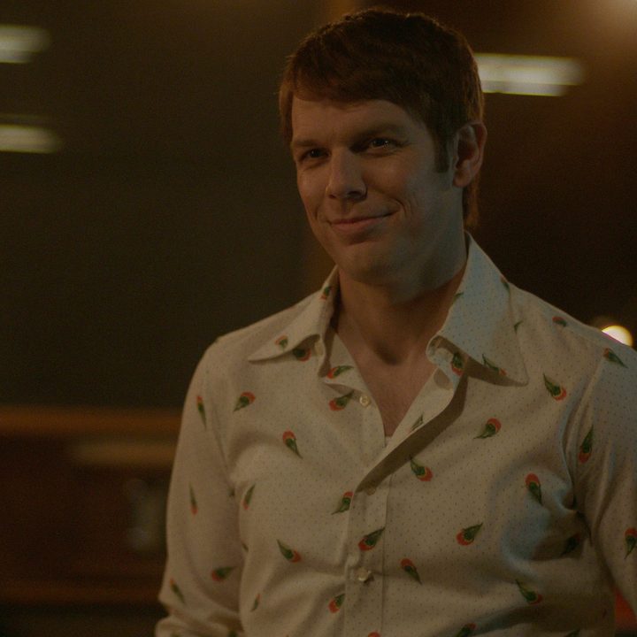 Jake Lacy creepily smiling in a scene from A Friend of the Family.