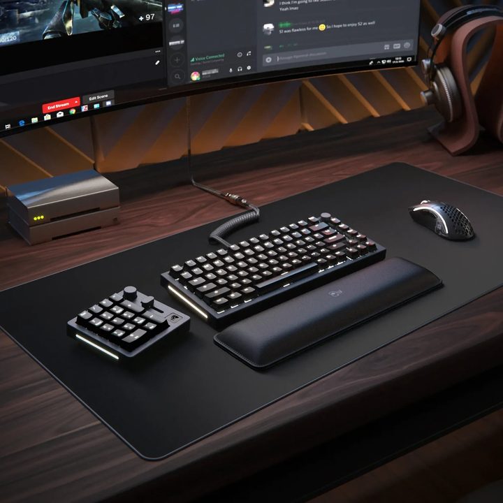 GMMK NumPad next to a mechanical keyboard.