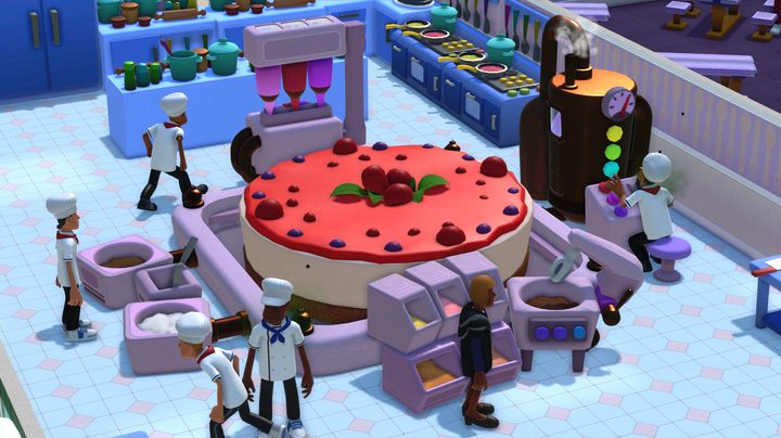 Chefs making a giant cake.