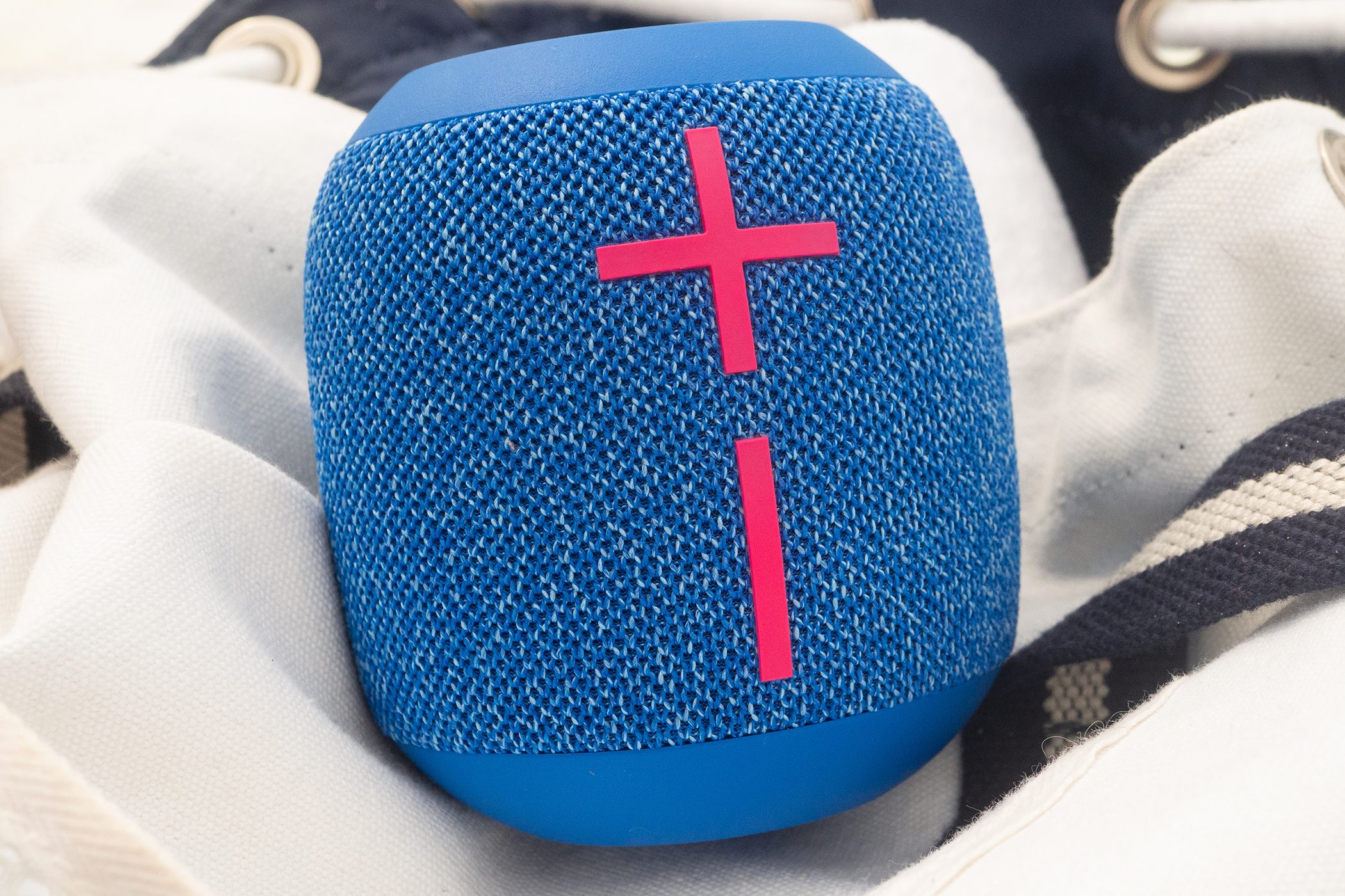 The Wonderboom 3 speaker is sitting on a beach bag at the beach.