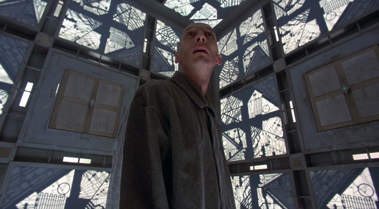 A prisoner wakes up inside a giant cube in the 1997 film Cube