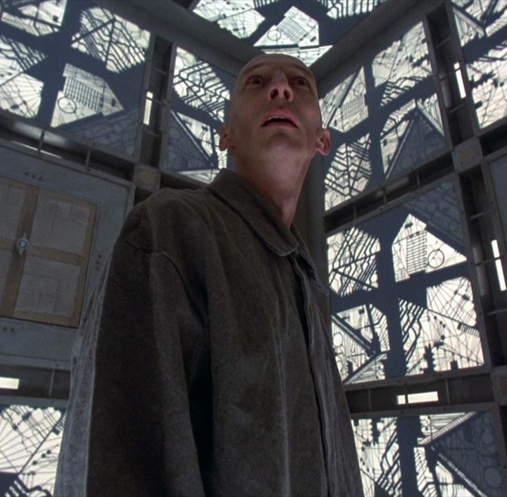 A prisoner wakes up inside a giant cube in the 1997 film Cube.