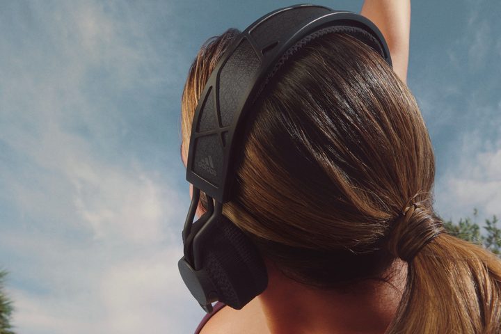 Woman wearing Adidas RPT-02 SOL solar-powered headphones.