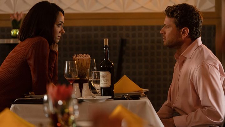 A man and a woman sit at a table in Collide.