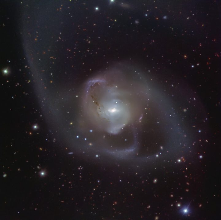 The galaxy NGC 7727 was born from the merger of two galaxies that started around a billion years ago. The cosmic dance of the two galaxies has resulted in the spectacular wispy shape of NGC 7727. At the heart of the galaxy, two supermassive black holes are spiralling closer to each other, expected to merge within 250 million years, the blink of an eye in astronomical time. This image of NGC 7727 was captured by the FOcal Reducer and low dispersion Spectrograph 2 (FORS2) instrument at ESO’s Very Large Telescope (VLT).
