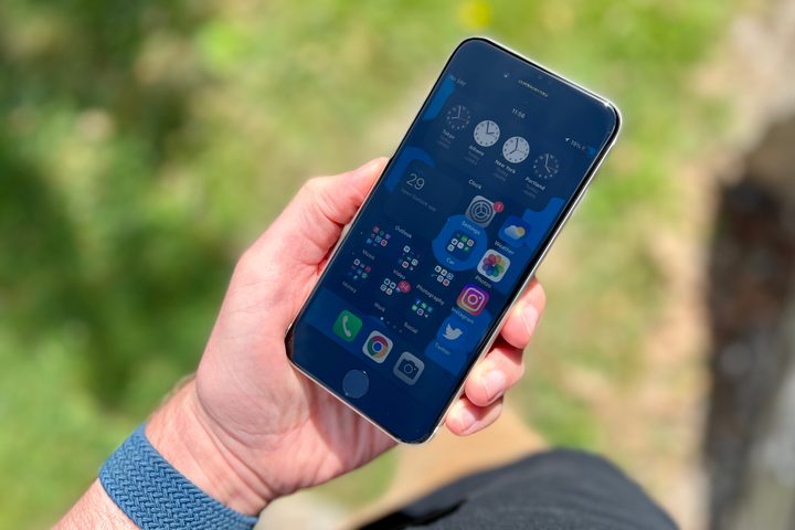 iPhone SE (2022) held in a mans hand.