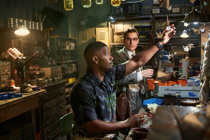 Jamie Foxx and Dave Franco stand in a workshop filled with vampire-killing tools.
